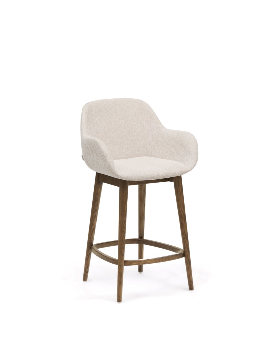 Konna stool in beige and solid ash wood legs in a dark finish. 65 cm